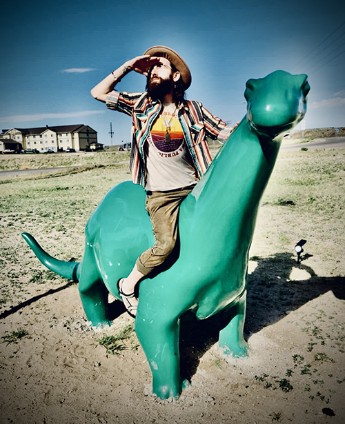 Logan Strong atop his trusty steed, searches for the perfect venue to showcase his musical talents.