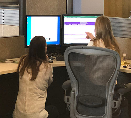 two women working at a computer