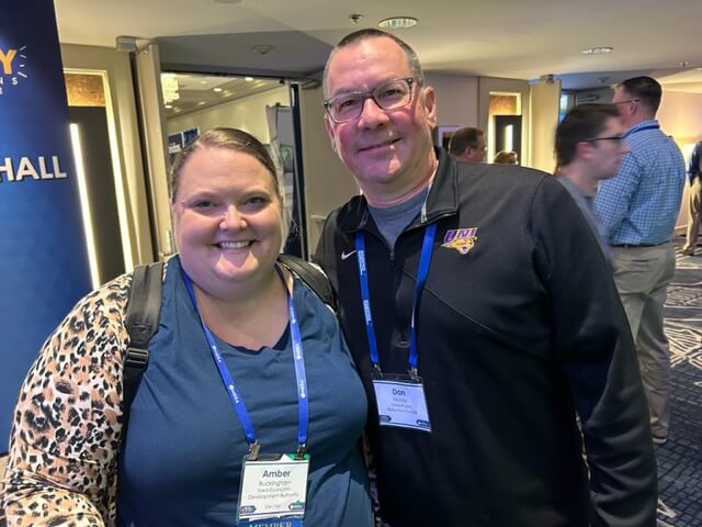 Staff member Dan Nickey poses with another conference goer in Daytona Beach